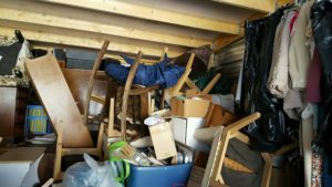 Preparing to buy a unit - image of clothing furniture in an abandoned storage locker