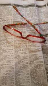 a pair of red glasses on a newspaper article about storage units up for auction How To Keep Your Storage Unit Items Safe
