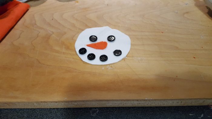 Snowman pillow face with eyes nose mouth hot glued on