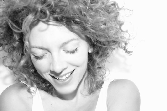 woman with curly hair smiling Overhauling Your Life: It Can Be That Simple