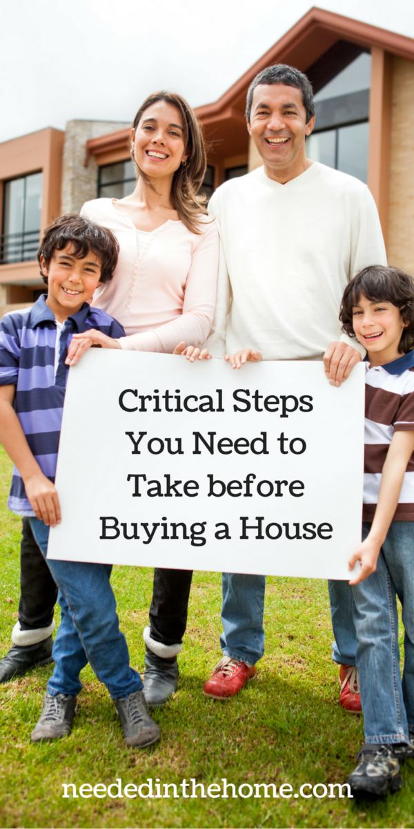family in front of house holding sign Critical Steps You Need To Take Before Buying A House