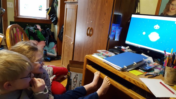 two elementary children using The Starfall Home Membership online program at a desktop computer