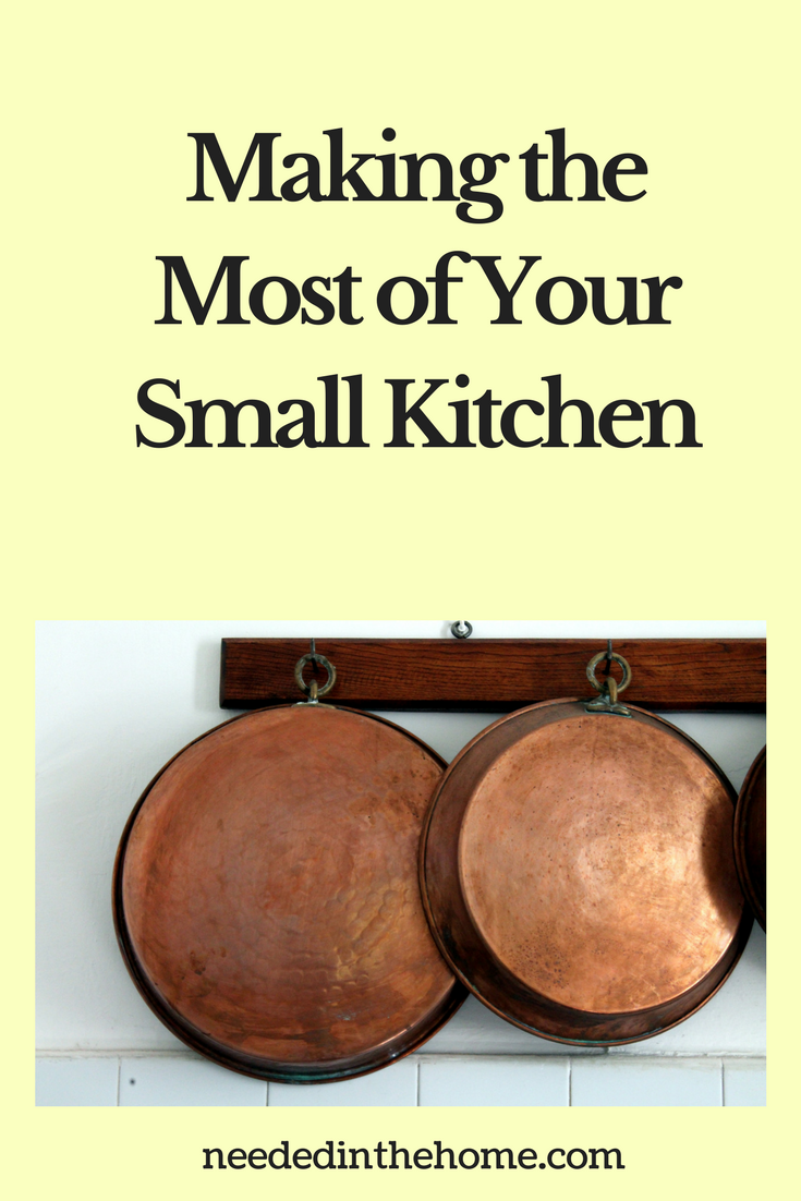 copper pans hanging from hooks in the kitchen Making the Most of Your Small Kitchen neededinthehome.com