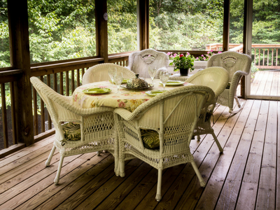wicker furniture chairs table flowers wood deck patio backyard