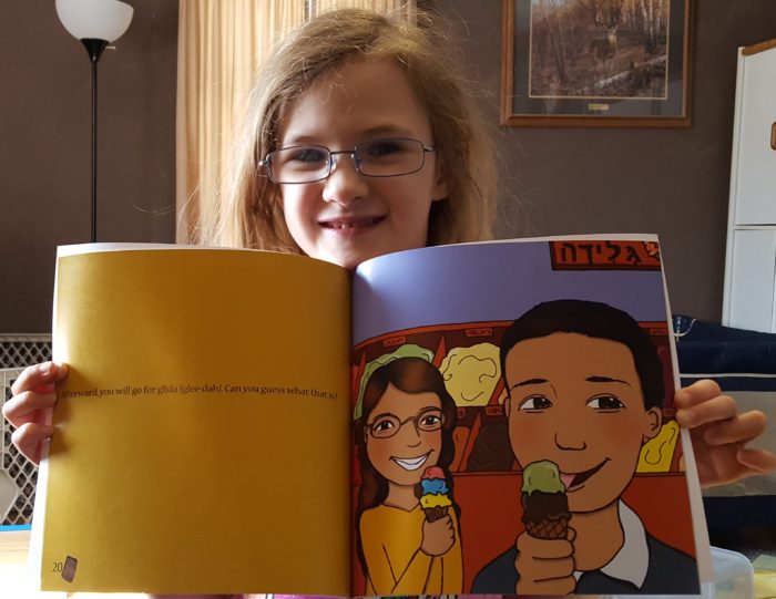Product Review of If You Were Me And Lived In Israel paperback book by Carole P. Roman blond girl wearing glasses holding book