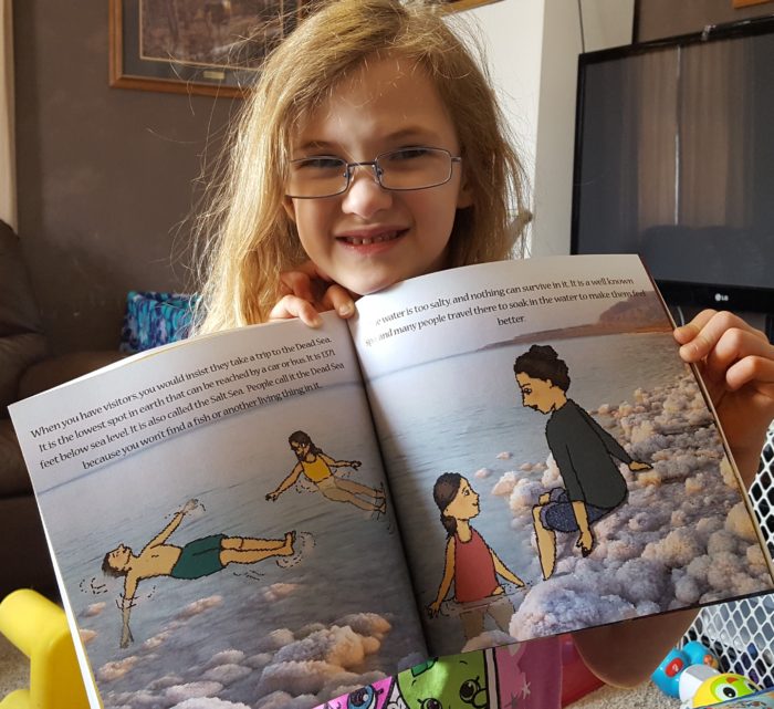 Product Review of If You Were Me And Lived In Israel paperback book by Carole P. Roman blond girl wearing glasses holding book