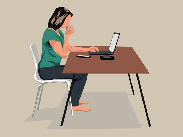 desk sitter sofa alternatives woman sitting at a table with laptop and coffee
