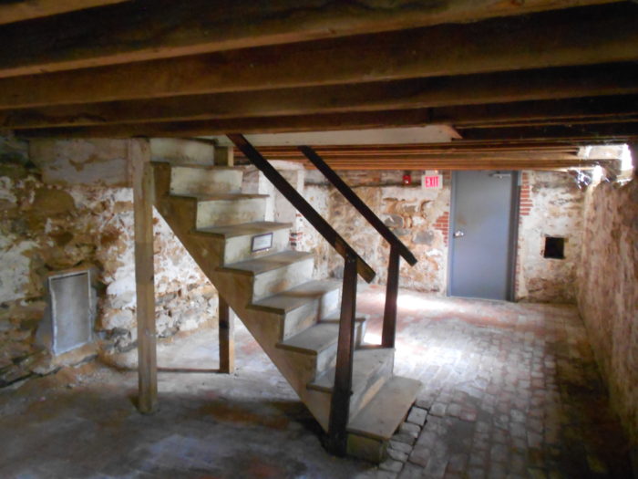 Basement conversion stairs leading to a disheveled basement ready to remodel