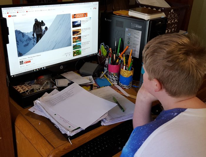 a preteen boy watches a YouTube video Let It Snow for a creation unit study on snow from Creation Illustrated Magazine