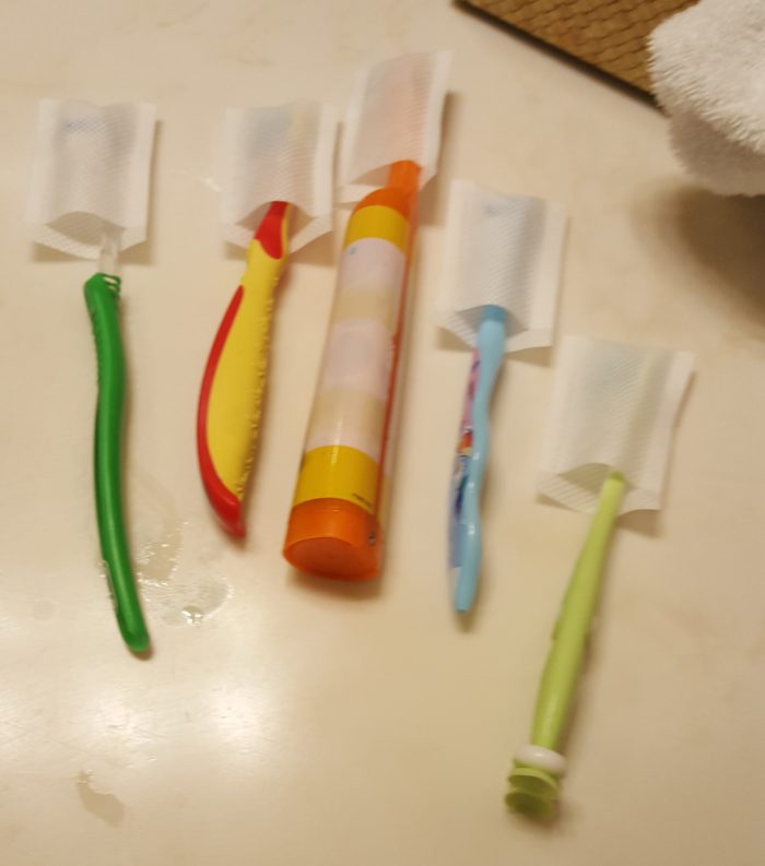 IntelliDent Toothbrush Shields on five toothbrushes