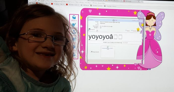 Kids Email review photo of young girl in glasses next to computer screen of email message she received from her older brother