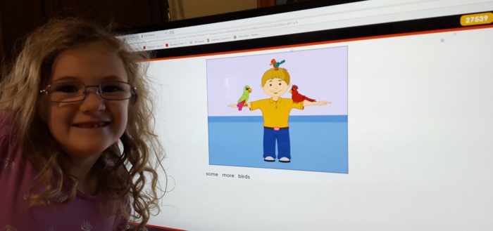 Review of ASD reading computer learn to read program for struggling readers image girl wearing glasses next to computer screen image of a boy with some more birds