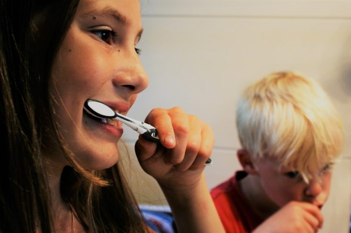 Organize your finances image mom and son brushing teeth together