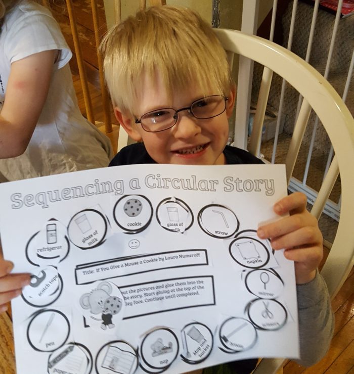 Home School Navigator image of boy with glasses holding his completed worksheet for Level Red