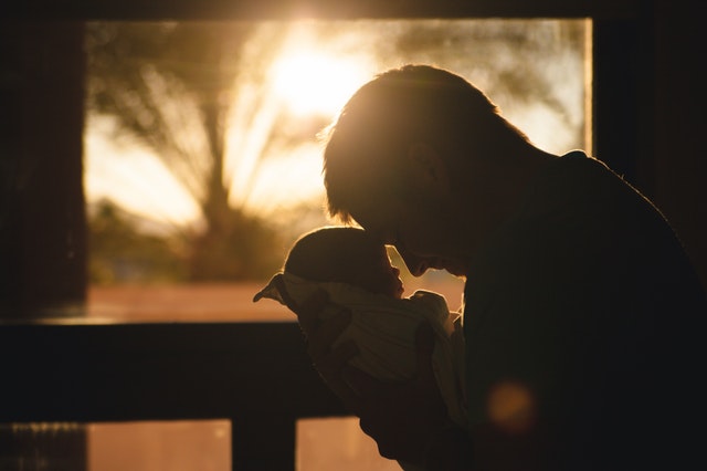 Skills your teens will need image Dad holding newborn baby