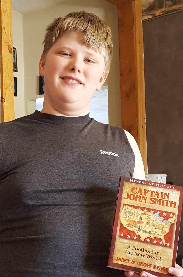 Captain John Smith book review teen boy holding his chapter book for homeschool