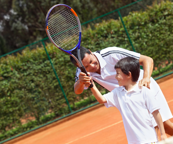 Health and Wellness Home Business image Tennis Coach and student with tennis racket