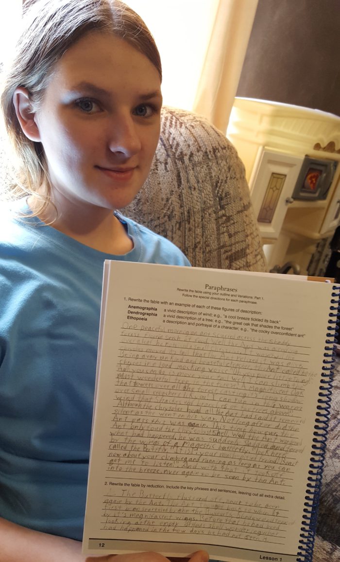 Classical Composition Fable and Narrative Product Review of Memoria Press Teen girl holding up her writing work in a workbook