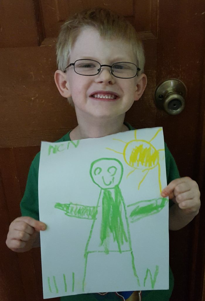 Product Review of ARTistic Pursuits image boy holding picture he drew of a figure and sun