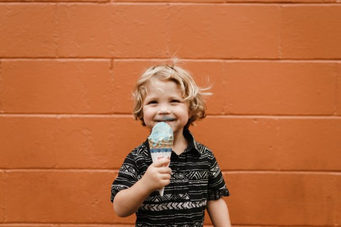 Secret to a fulfilling life image happy little boy eating his ice cream cone