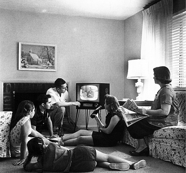 Creating an entertainment room black and white photo family watching television