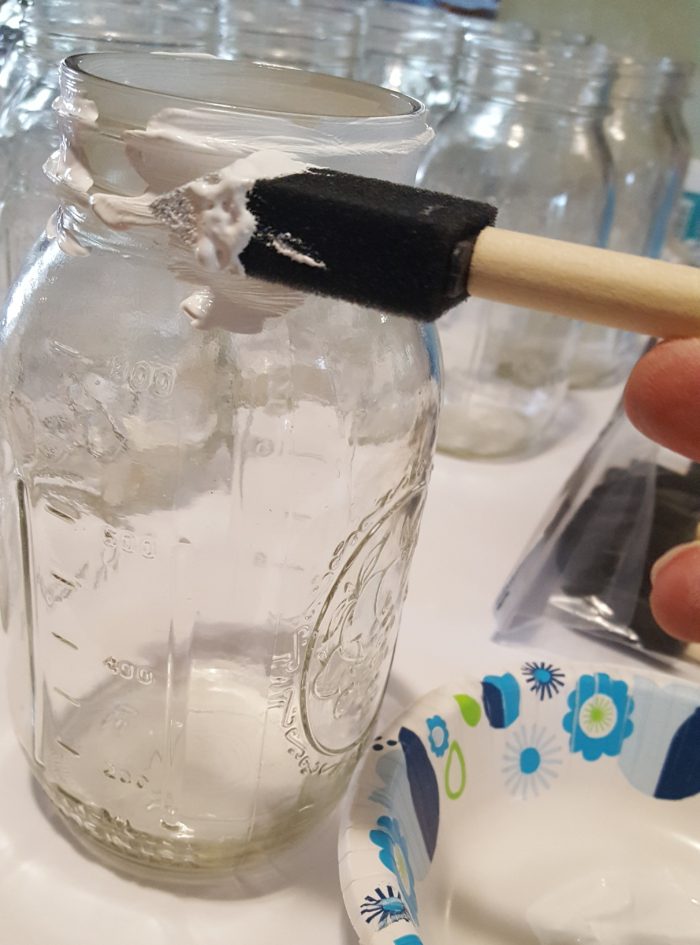 Mason Jar Crafts Tutorial foam brush painting the rim of a glass jar