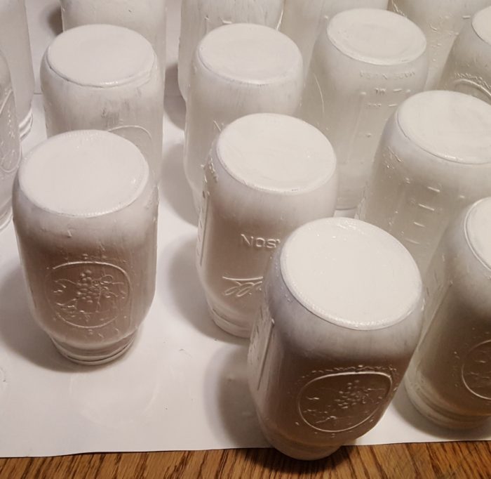 Mason Jar Crafts several inverted mason jars drying after being painted