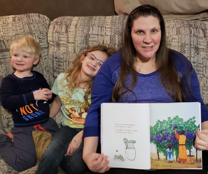 Psalm 136 book review A homeschool mom shows the vibrant illustrations in a picture book she reads to her children
