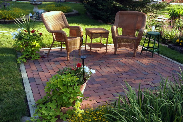 backyard ready for summer wicker brick patio furniture potted plants
