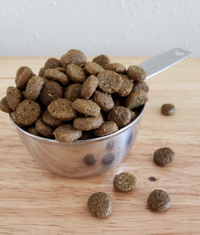 Honest chewy review overflowing tin measuring cup of dog food kibble