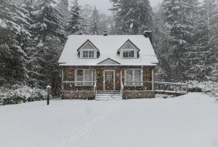Home safe this winter with preventative maintenance house in forest on a snowy day