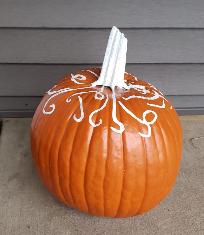 Pumpkin frost decor painted on a pumpkin with white acrylic paint and spray fixative
