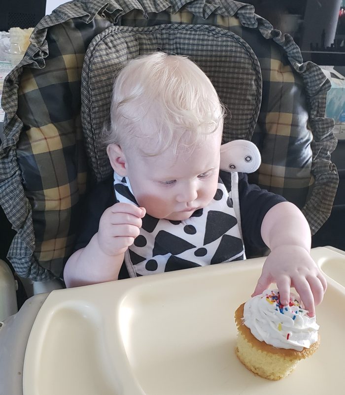 feeding bibs with snaps on one year old baby girl with smash cake cupcake black and white geometric bib