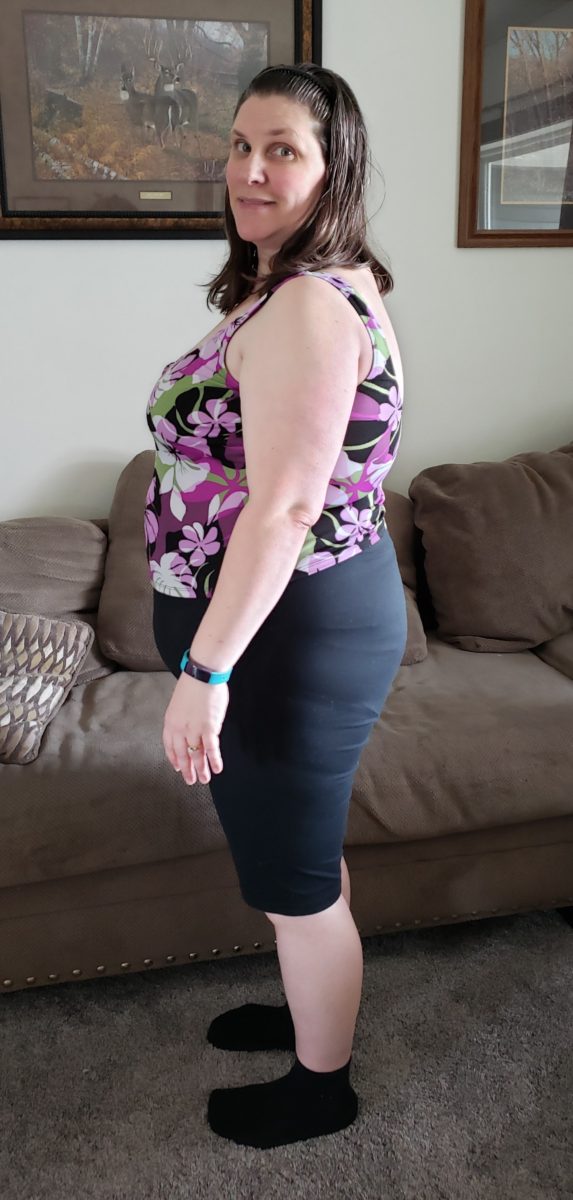 Starting a weight loss program obese woman in her forties side view living room