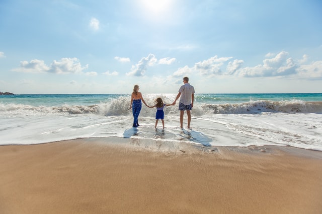 Using insurance to protect yourself family at beach sand ocean