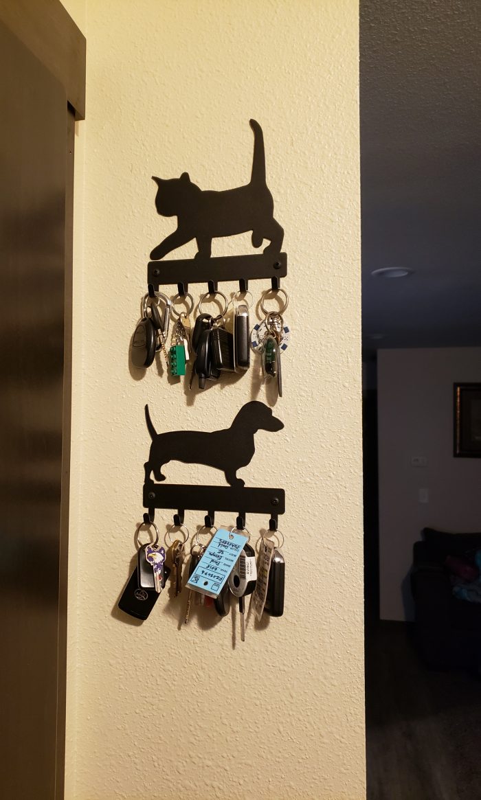 cat key holder with keys and mini dachshund dog key holder with keys on a wall