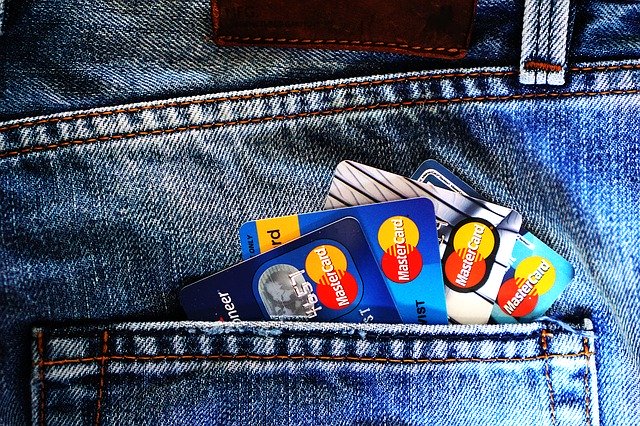 debt settlement several credit cards in back pocket of jeans
