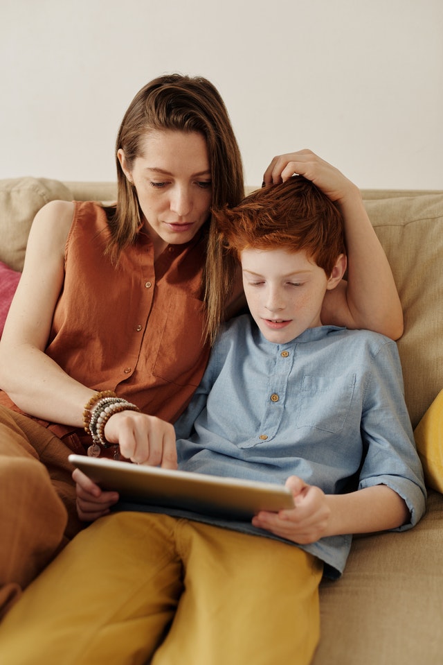 Keep kids safe from technology mom and teen son using tablet on internet safely