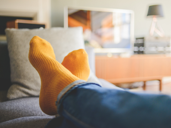 Making your home less stressful socked feet up on soft couch