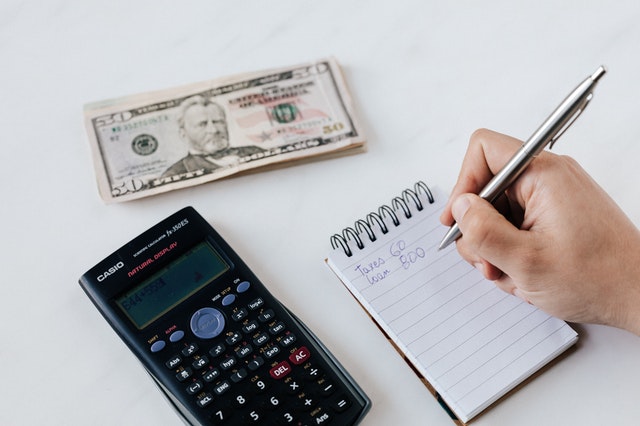 pinterest-pin-description boost household finances calculator money pen notepad hand writing