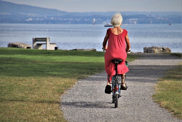long term care plans senior woman on bike harbor view