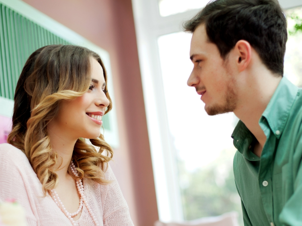 image of couple smiling at each other trying fun at home dates ideas