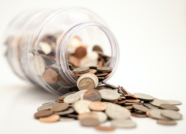 financial lessons to get started article image of coins spilling from glass jar
