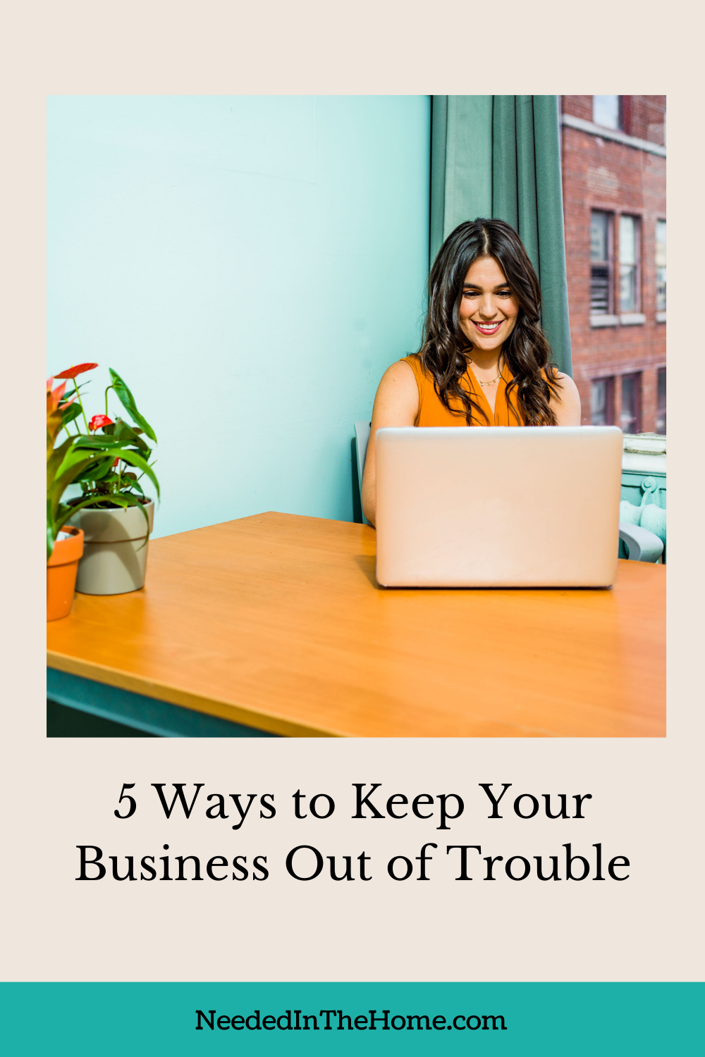 pinterest-pin-description smiling woman working at laptop desk plants 5 ways to keep your business out of trouble neededinthehome