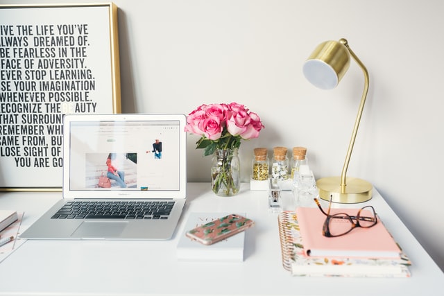 home office that inspires success motivational sign fresh roses in clear vase laptop desk light