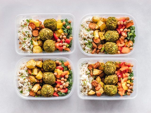 making mealtimes easy containers of meatballs potatoes chickpeas rice tomatoes garnish 