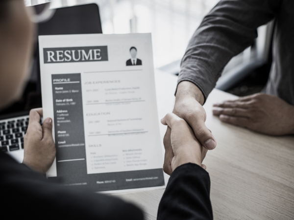 hiring wrong business talent man holding resume in job interview shaking hands with prospective employee