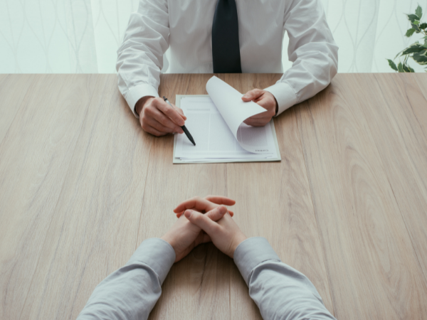 hiring wrong business talent man in tie and shirt with papers interviewing person with folded hands