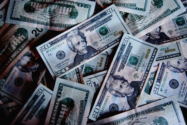 supplement retirement income pile of United States twenty dollar bills