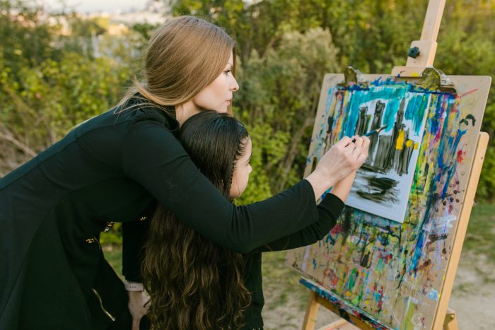 homeschooling kids better mom and daughter painting picture at an easel together
